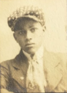 Sepia image of young Owen Troy Sr. wearing a cap.